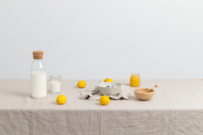 Bottle of milk, glass of milk, bowls and lemons