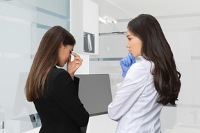 A crying female standing next to a doctor