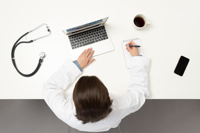 A female doctor making notes