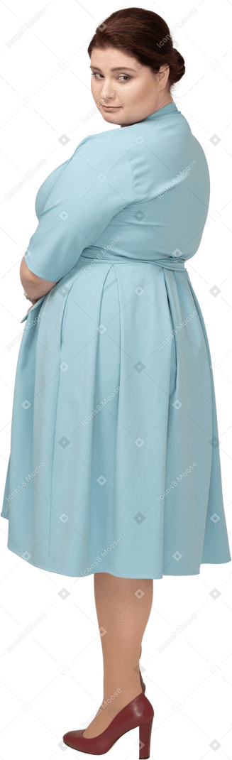 Woman in blue dress posing in profile