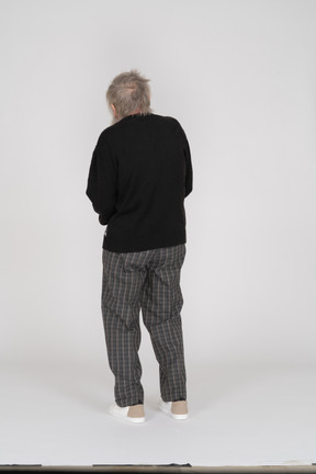 Back view of a standing old man