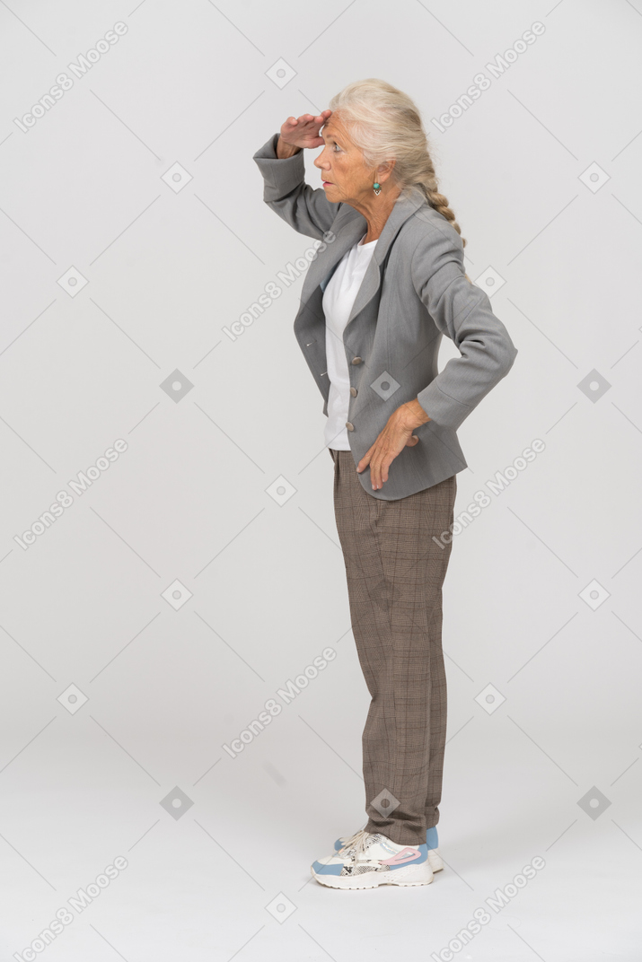 Side view of an old lady in suit looking for someone