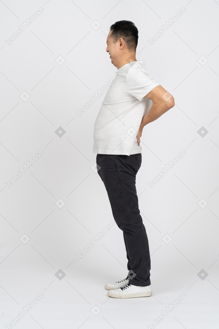 Side view of a man suffering from back pain