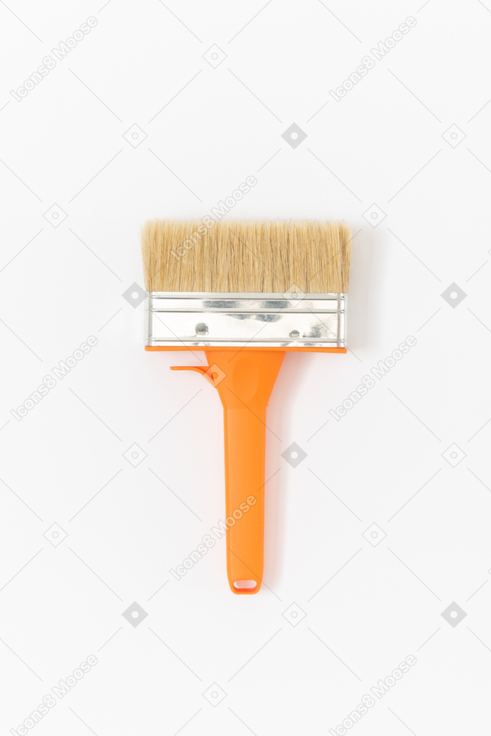 Bright orange paintbrush for painting your room in happy colours