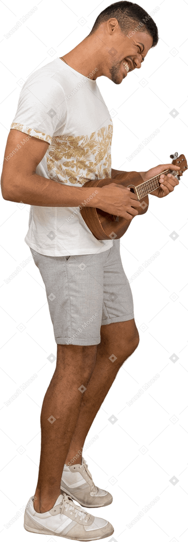 Side view of a man playing ukulele excitedly