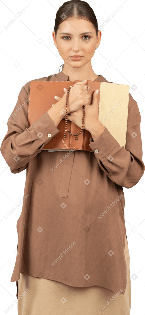 Woman holding book to chest