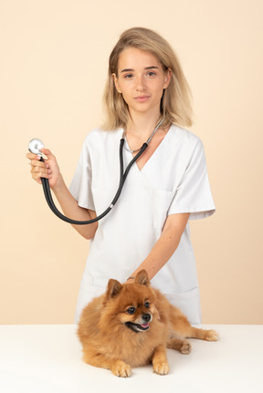 Attractive veterenarian ready to examine a spitz