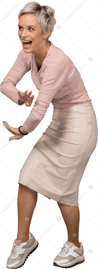 Side view of a happy woman in casual clothes bending down and gesturing