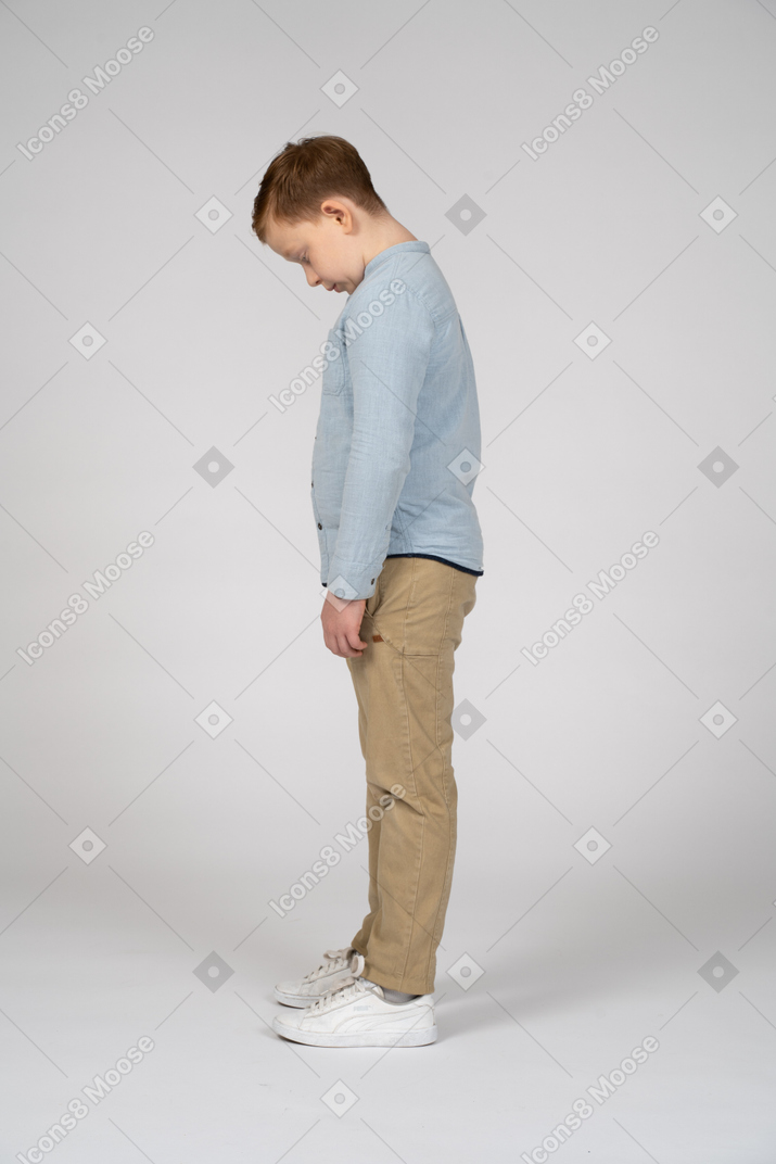 Side view of a boy bending head down