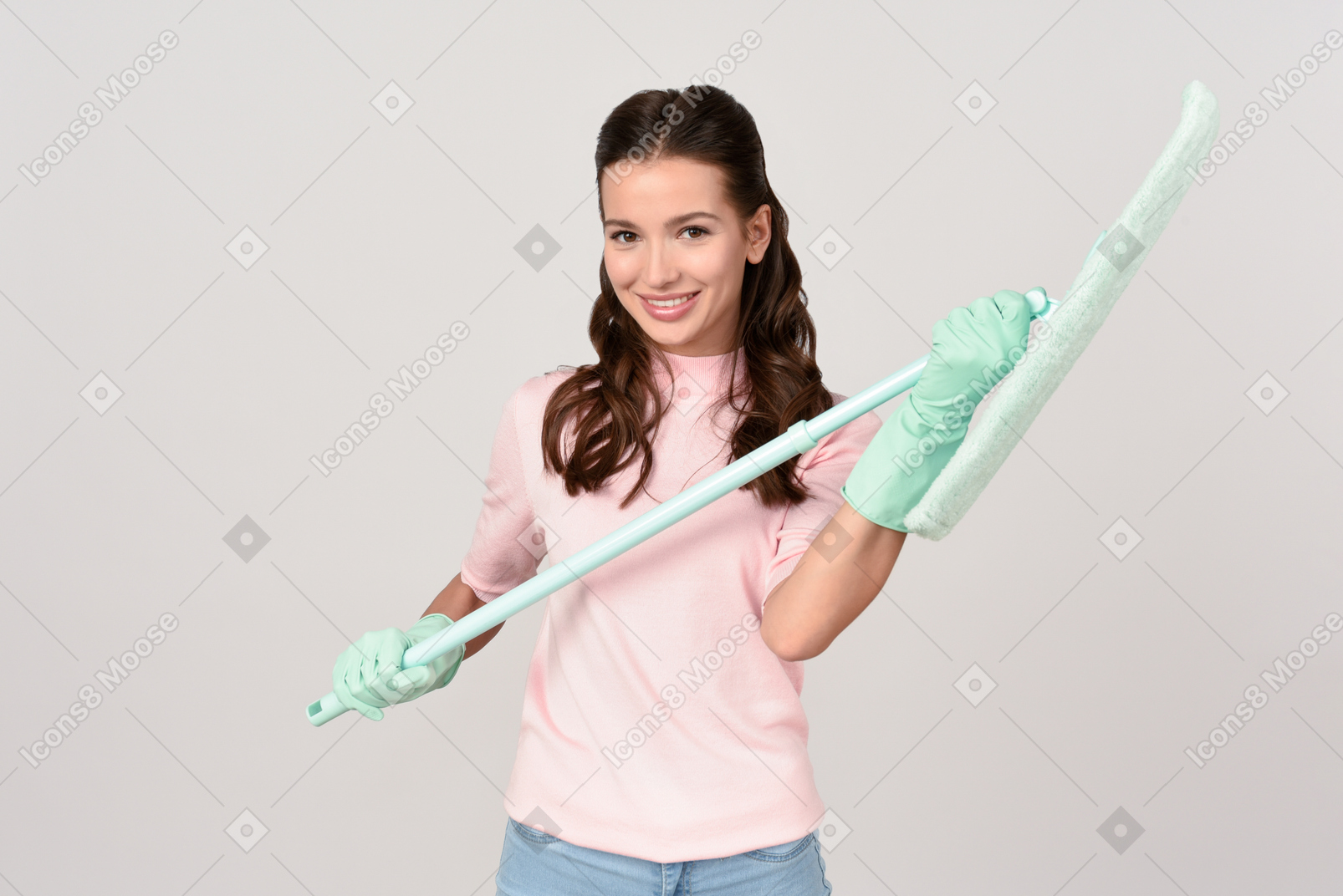 Attractive young woman holding a mop