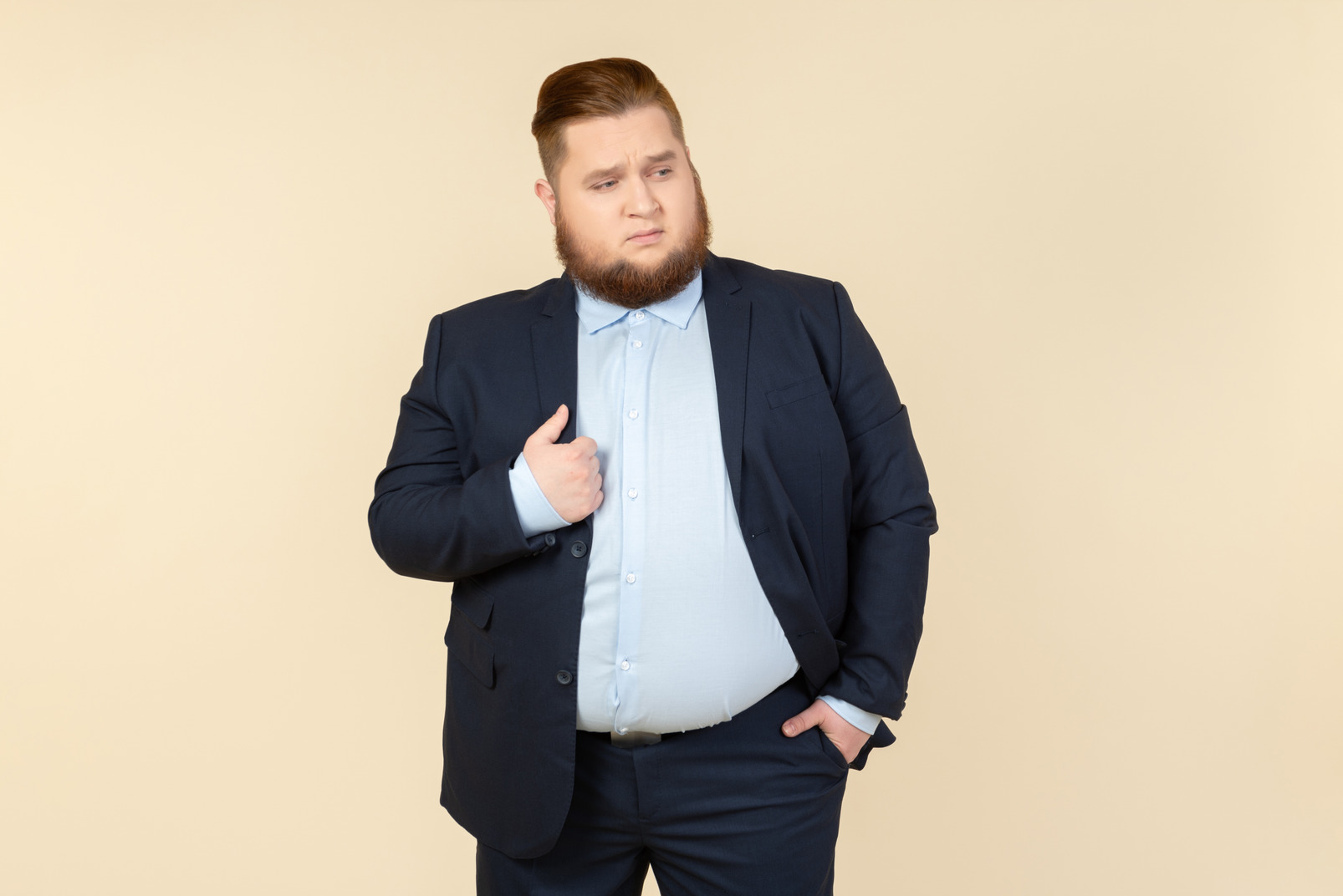 Young overweight man in suit touching jacket with a hand
