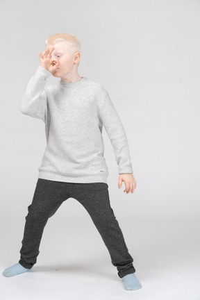 Little boy showing ok sign