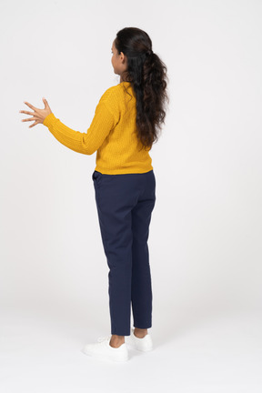 Vista lateral de uma garota com roupas casuais mostrando o tamanho de algo