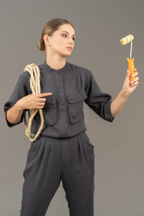 Confident woman holding a paint roller