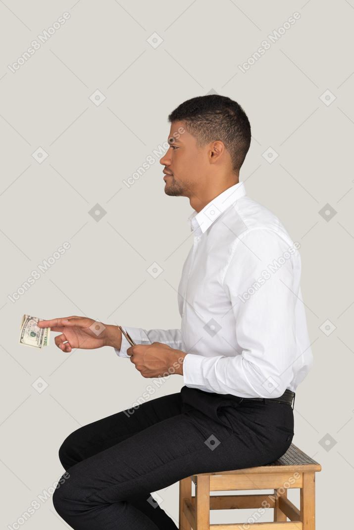 Businessman holding out money