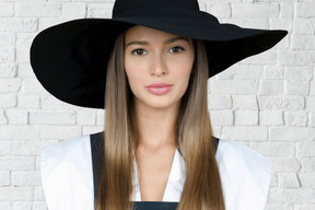 A woman wearing a black hat with long hair