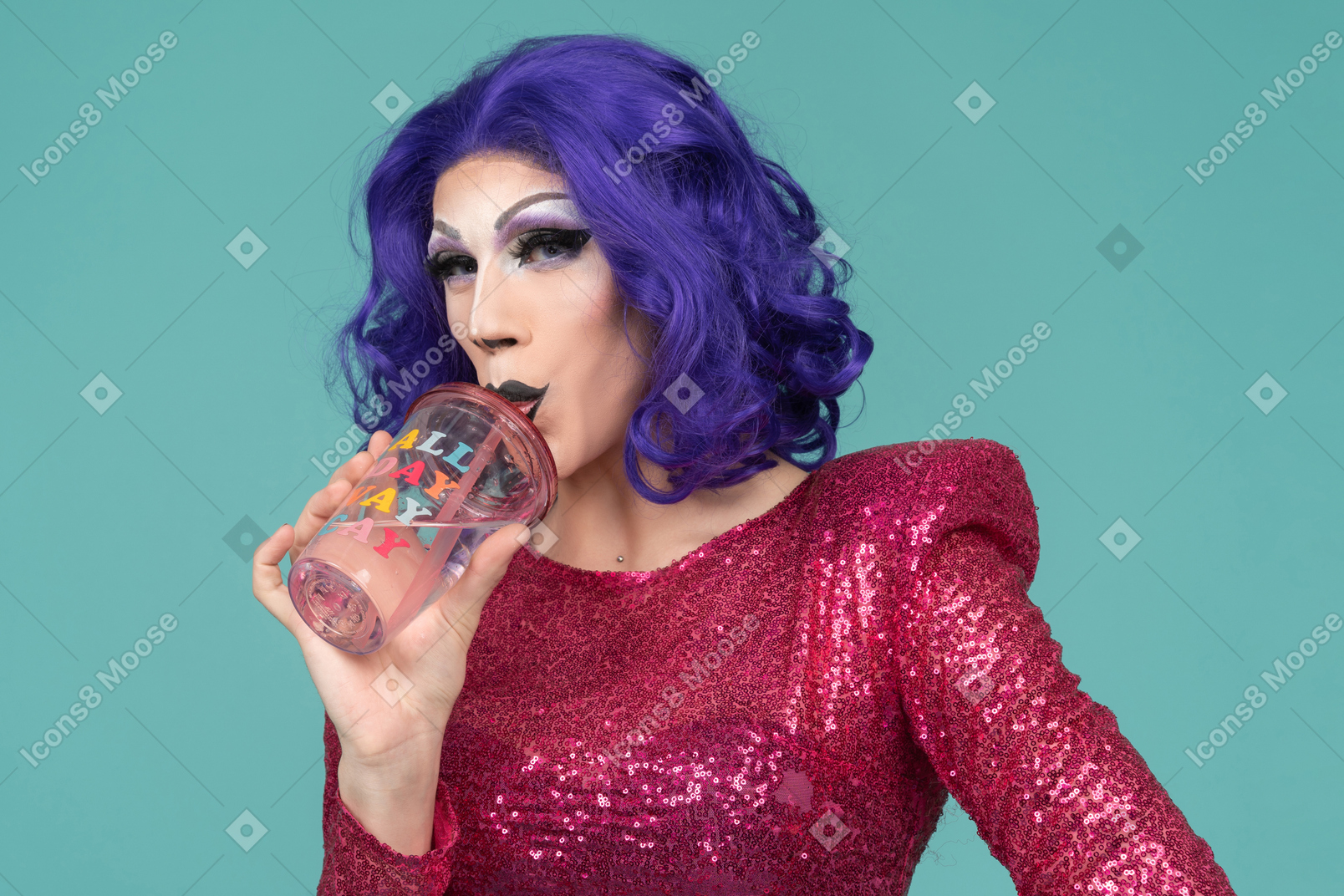Close-up of a drag queen drinking through straw