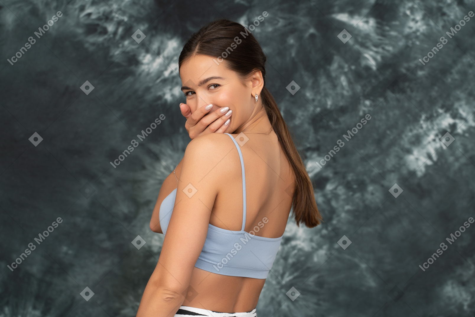 A portrait of laughing female athlete turned back