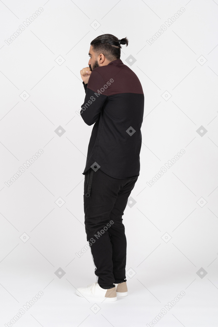 Side view of freezing man coughing