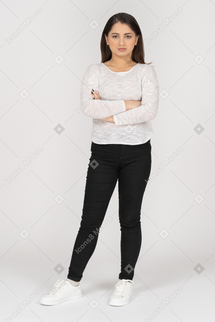 Annoyed girl standing with her arms crossed