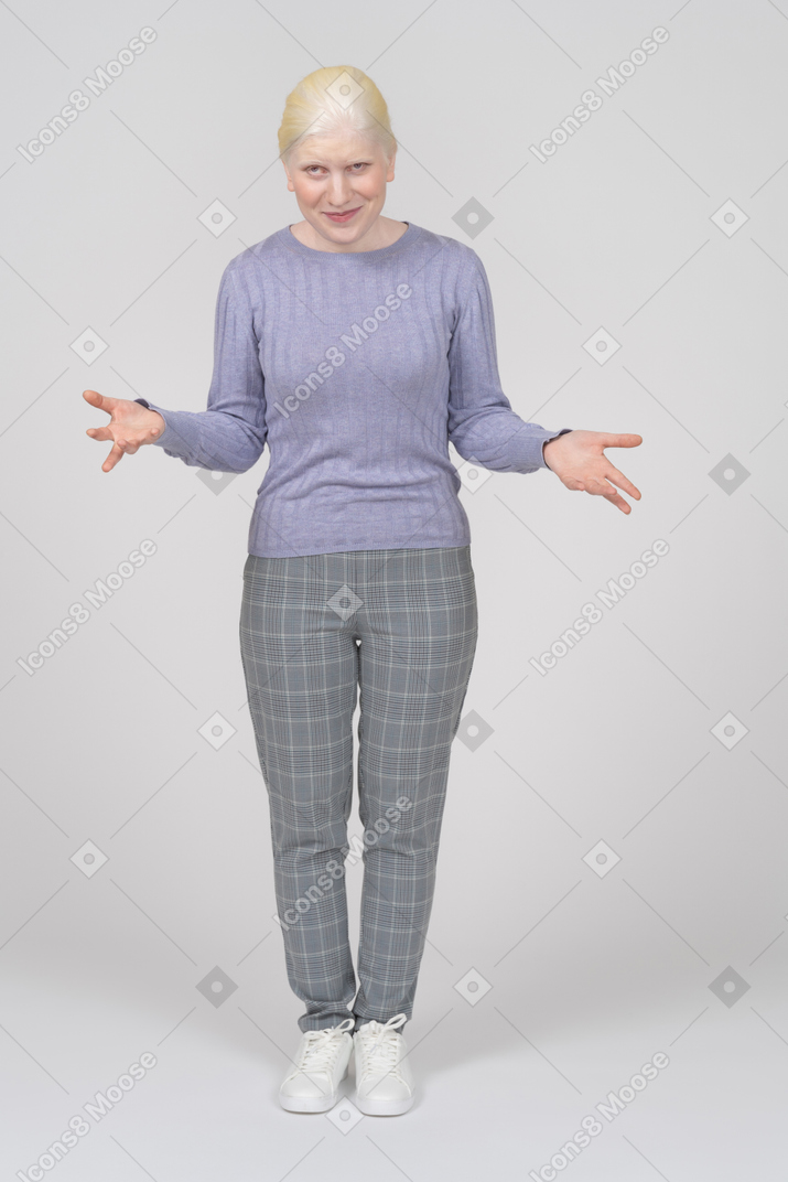 Smiling young woman shrugging