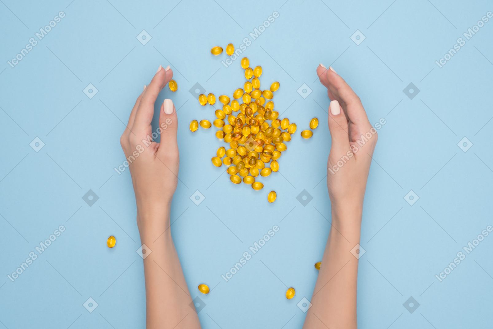 Fish oil pills dropped out female hands