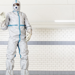 Man in a protective suit standing in a room