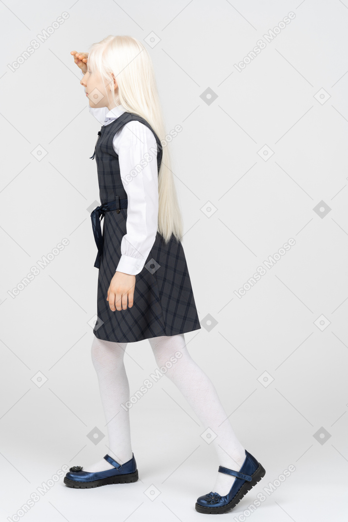 Side view of a schoolgirl looking into the distance