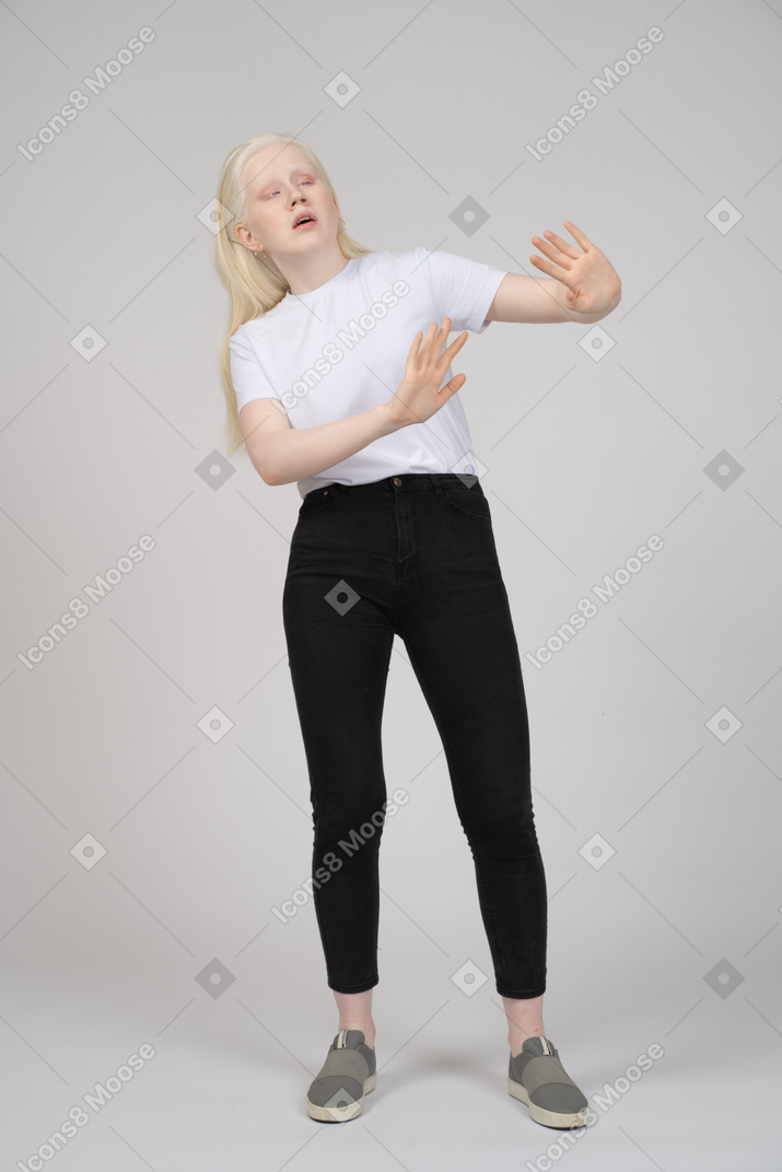 Standing young girl stretching out her arms