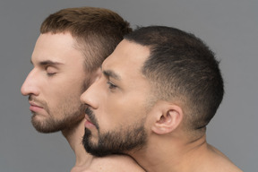 Close-up of young man putting head on partner's shoulder