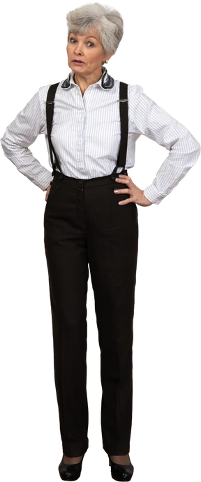 Full-length of an old questioning  female in suspenders putting hands on hips