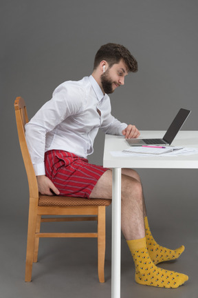 Businessman scratching bud while working remotely
