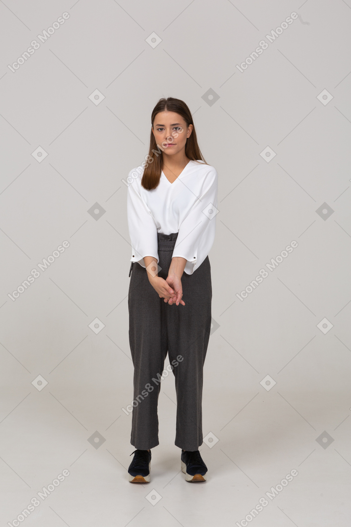Vista frontale di una giovane donna in abiti da ufficio che si tiene per mano insieme