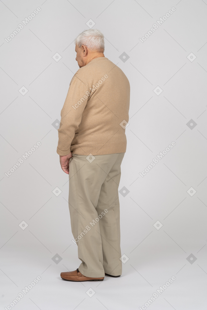 Side view of an old man in casual clothes standing still