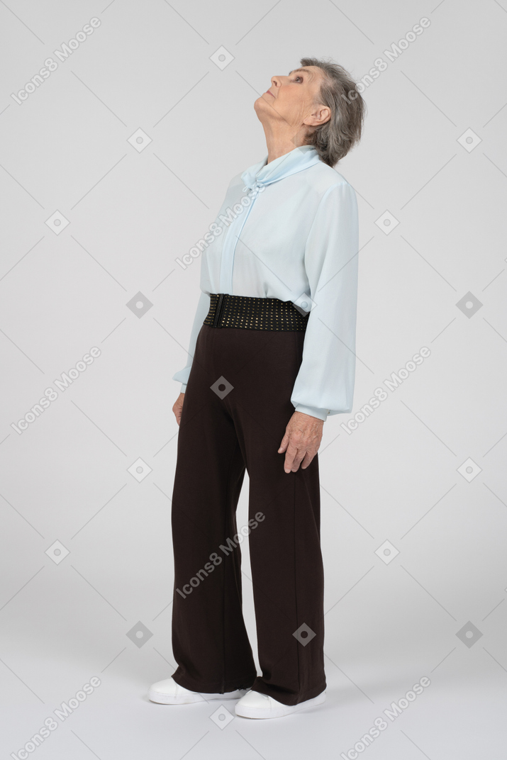 Old woman standing and looking up