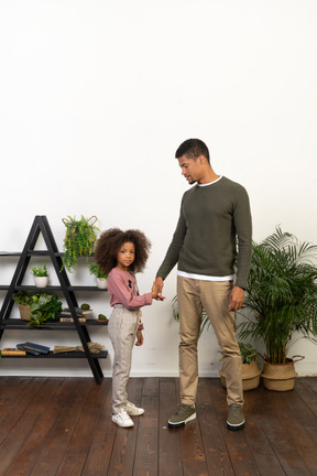 Father and daughter hold hands