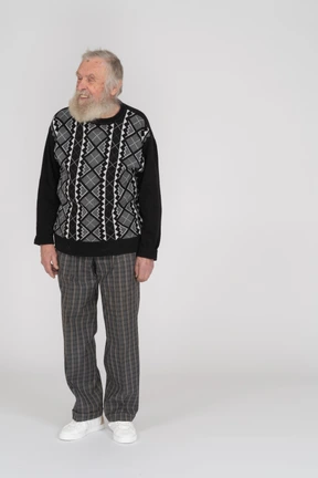Front view of smiling elderly man standing with closed eyes