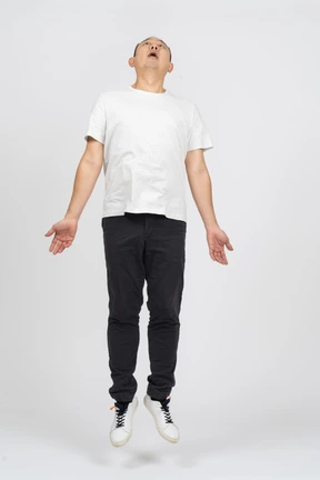 Man jumping with outstretched arms