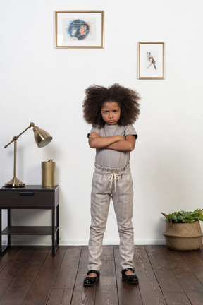 Good looking girl kid posing on the apartment background