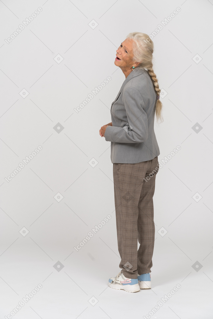 Rear view of an emotional old lady in suit