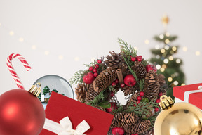 A christmas wreath, ornaments, and other items are on a table
