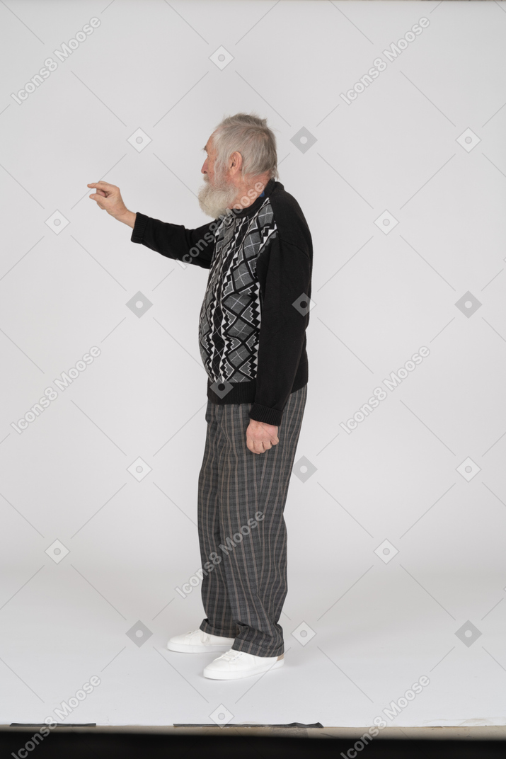 Side view of old man showing small gesture with fingers