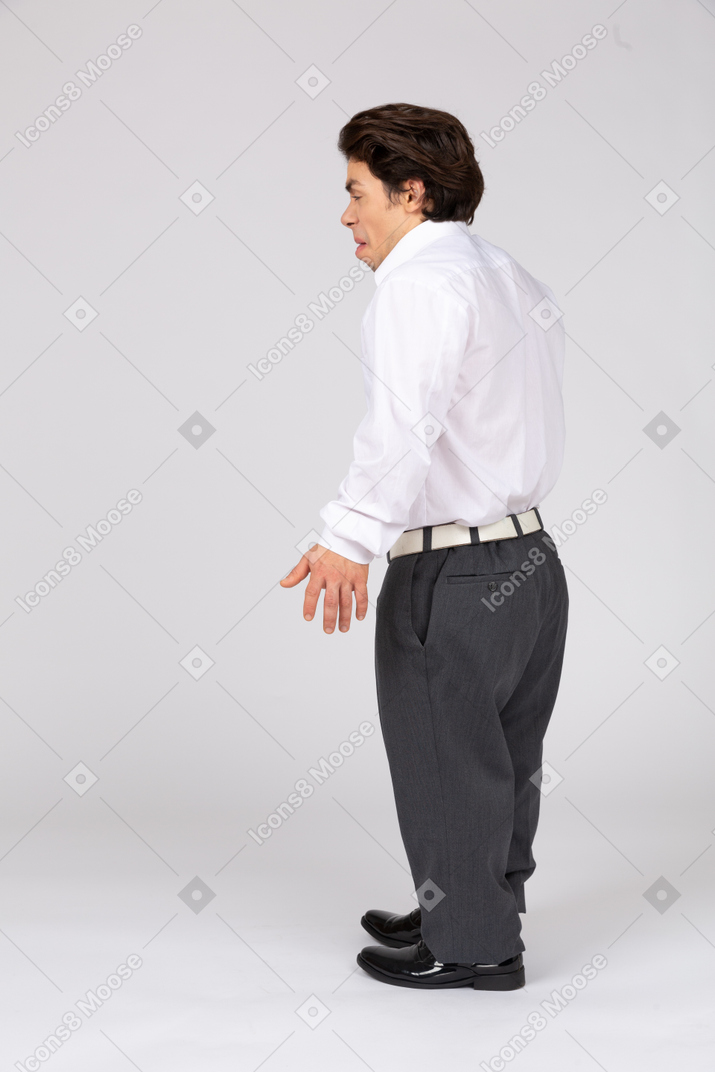 Side view of a scared young man in business casual clothes