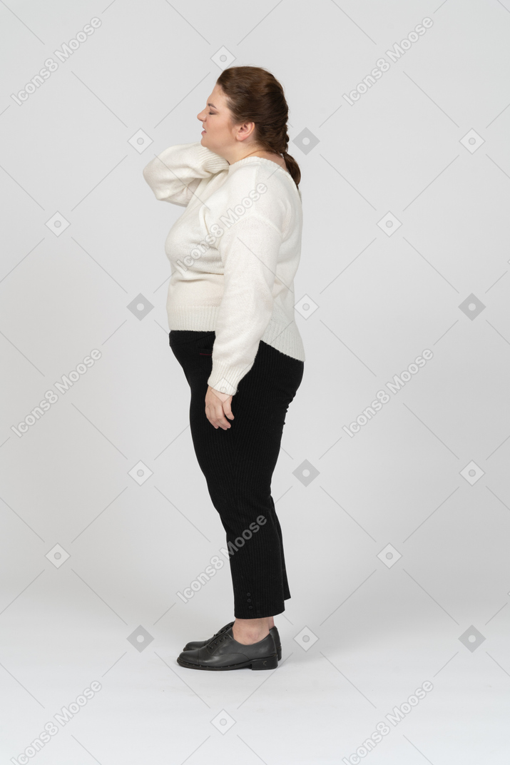 Plus size woman in casual clothes suffering from pain in neck