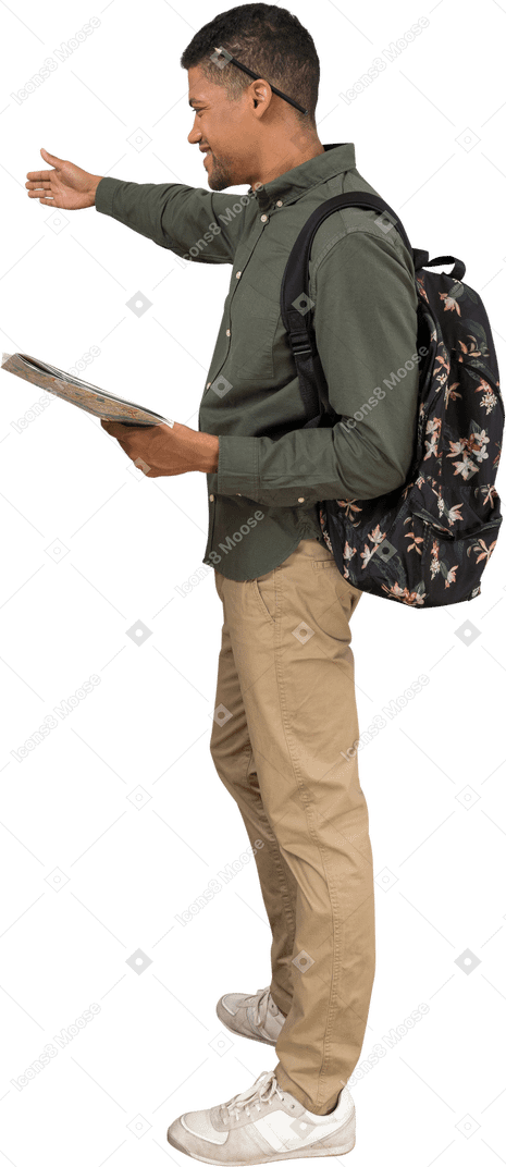 Side view of a man with a backpak and a map showing directions