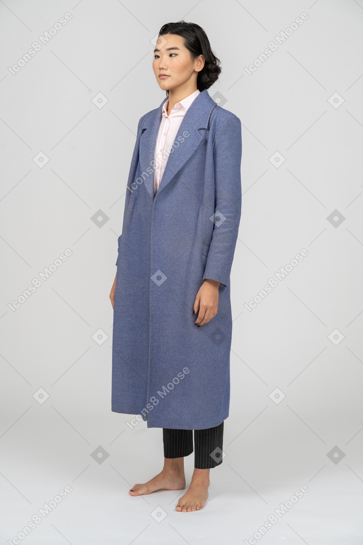 Woman in blue coat crossing her eyes
