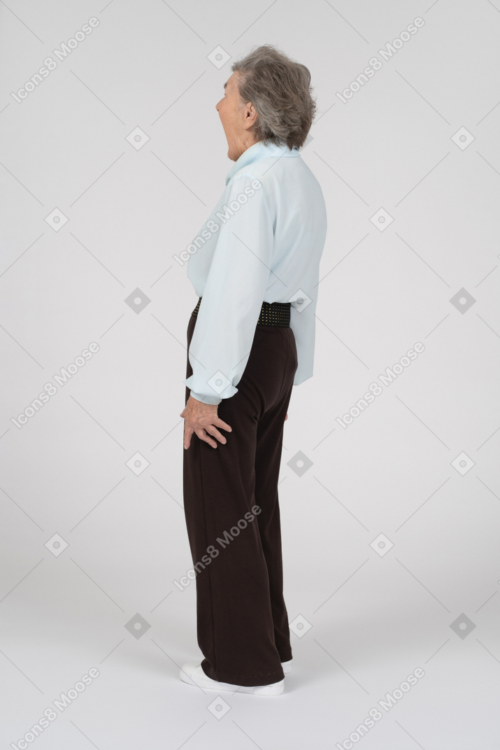 Back view of an old woman gaping