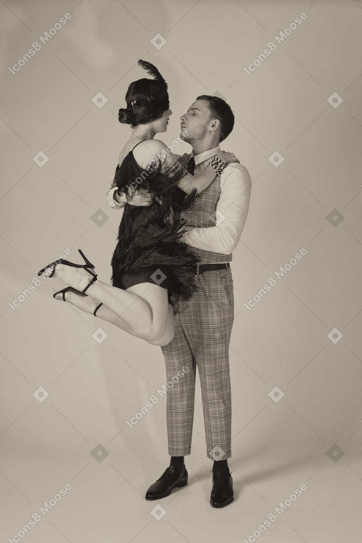 Young man lifting his beautiful dance partner