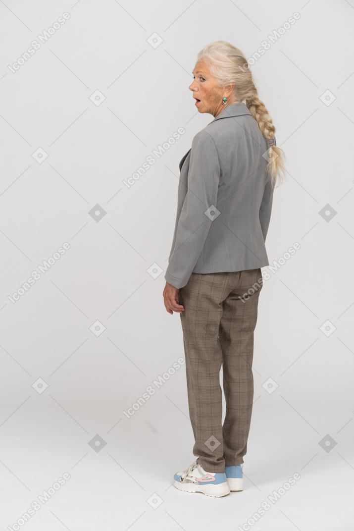 Rear view of an old lady standing with open mouth