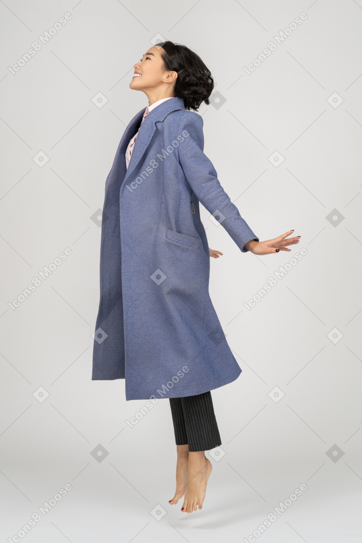 Excited woman spreading hands mid-air
